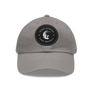 May include: Grey baseball cap with a black and white patch that says "Wake Surfer Lake Okoboji".