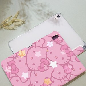 May include: Pink tablet case with a repeating pattern of Hello Kitty characters with stars and bows. The case is made of a soft, flexible material and is designed to protect your tablet from scratches and bumps.