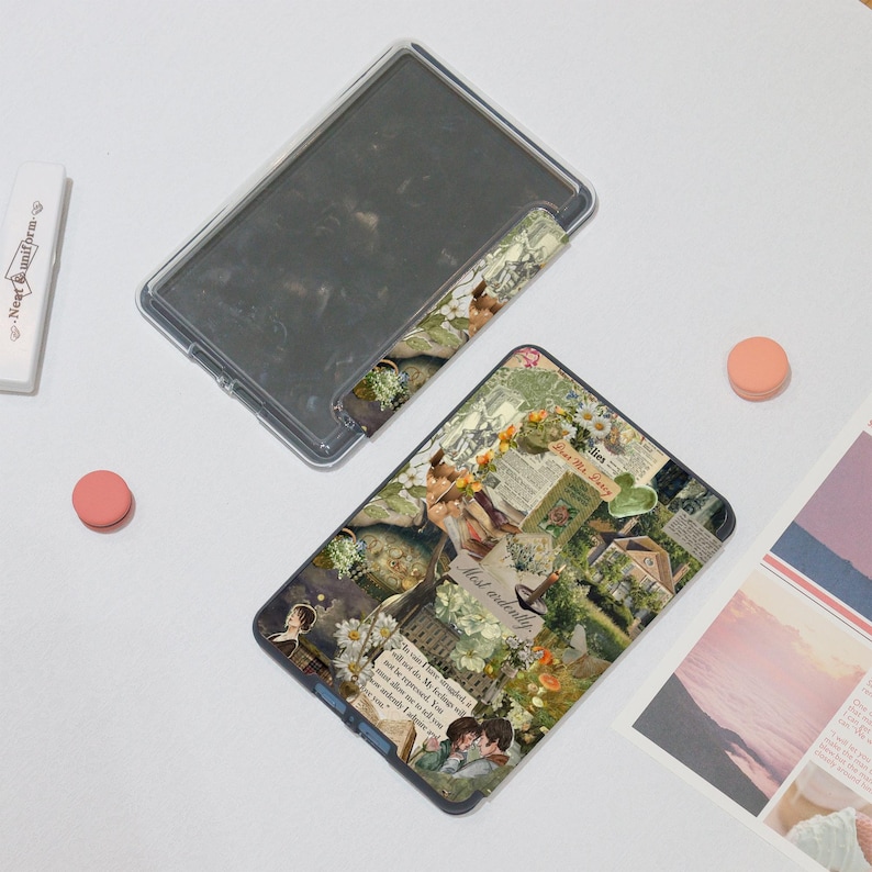 May include: A clear, rectangular phone case with a floral collage design. The collage includes images of flowers, houses, and text. A clear case and a pink circle are also visible.