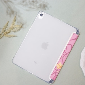 May include: A clear plastic case for an iPad with a pink and yellow patterned design on the back. The case has a cutout for the camera lens and the Apple logo is visible on the back.