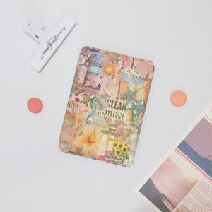 May include: A notebook cover with a colourful collage design featuring the text "CLEAN SUMMER" and "OUTER BANKS".