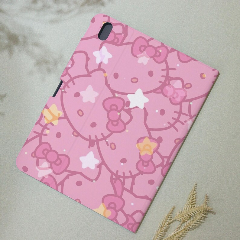 May include: Pink phone case with a repeating pattern of Hello Kitty characters and stars.