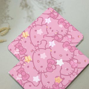 May include: Two pink laptop cases with a repeating pattern of Hello Kitty faces, stars, and bows.