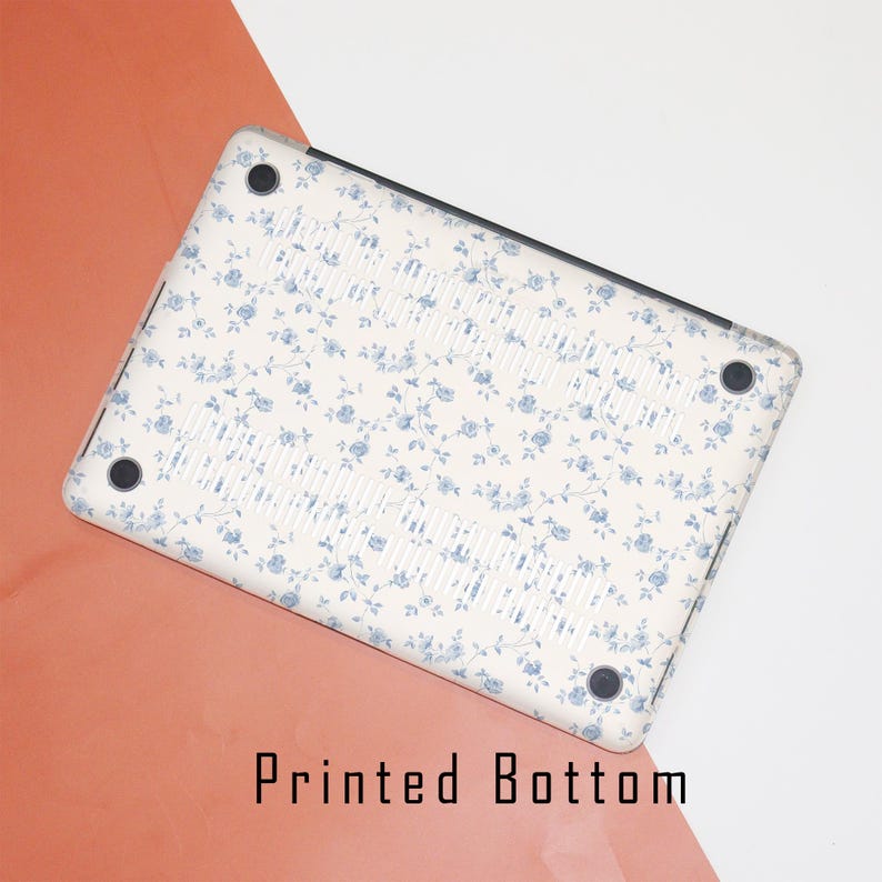 May include: A white laptop case with a blue floral pattern. The case has a printed bottom with the text "Printed Bottom".