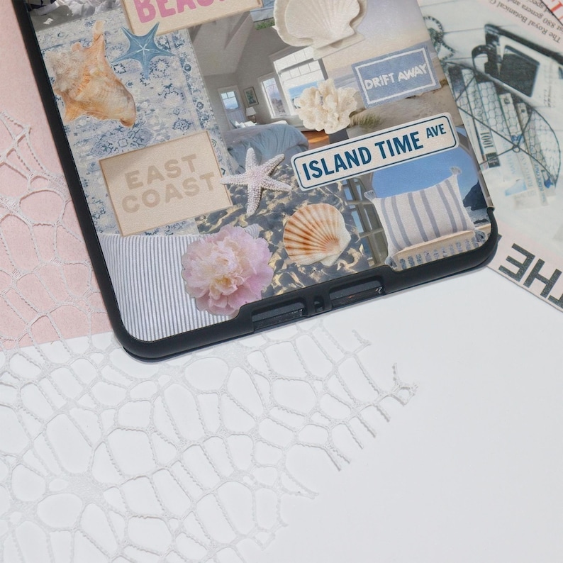 May include: A black phone case with a collage of images, including a seashell, a starfish, a flower, and text that says "East Coast", "Drift Away", and "Island Time Ave".