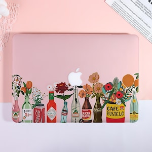 May include: A light pink laptop case featuring a colorful graphic print of various glass bottles and a yellow coffee can used as vases for assorted flowers. The design includes brand labels like Coca-Cola, Tabasco, and Cafe Bustelo.