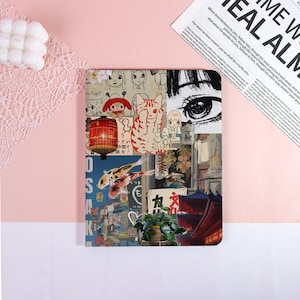 May include: A rectangular tablet case featuring a collage of Japanese-inspired illustrations, including a red lantern, koi fish, a cat, a large eye, and a temple structure. The design incorporates various graphic elements, text, and a potted plant.