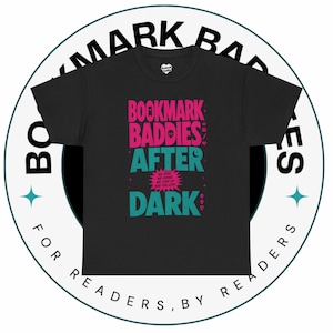 May include: Black t-shirt with the text "BOOKMARK BADDIES AFTER DARK" in pink and teal lettering. The shirt also includes the phrase "WE READ, WE JUDGE, WE STAY UP WAY TOO LATE". The shirt is surrounded by a circular logo that says "BOOKMARK BADDIES FOR READERS, BY READERS".