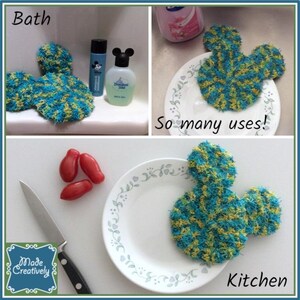 May include: Three blue and yellow crocheted Mickey Mouse-shaped scrubbers. The scrubbers are shown in three different settings: a bathroom, a kitchen, and a plate with tomatoes. The text "So many uses!" is written below the scrubber in the bathroom setting. The text "Kitchen" is written below the scrubber in the kitchen setting.