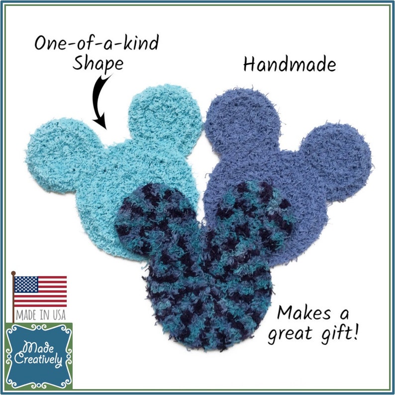 May include: Three handmade, fuzzy, blue and turquoise Mickey Mouse-shaped ornaments. The ornaments are made in the USA and are a great gift. The text "One-of-a-kind Shape" and "Handmade" are written on the image.