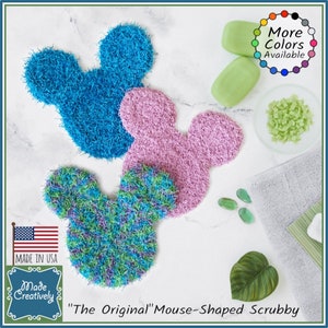 May include: Three mouse-shaped scrubbies in blue, pink, and green and purple. The scrubbies are made of yarn and are designed to be used in the shower or bath. The scrubbies are handmade and are available in a variety of colors. "The Original" Mouse-Shaped Scrubby.