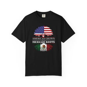 May include: Black t-shirt featuring a tree design with the American flag as the crown and the Mexican flag as the roots. The text "AMERICAN GROWN WITH MEXICAN ROOTS" is printed below the tree.