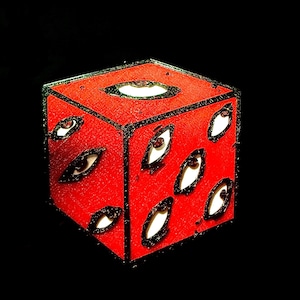 May include: A red cube-shaped pin with black outlines and white eyes. The pin has a 3D effect.