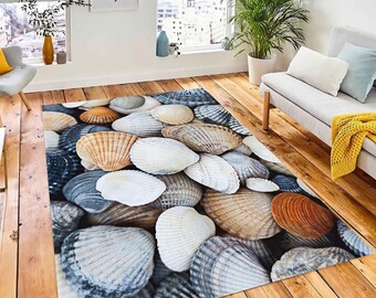 May include: A rug with a close-up image of various seashells in shades of white, brown, and gray. The shells are arranged in a random pattern, creating a natural and organic look.