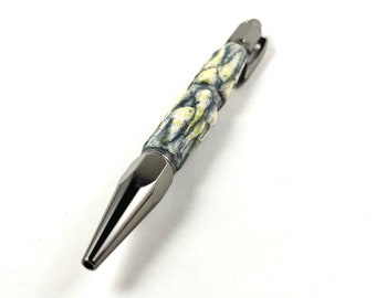 May include: A black and white patterned pen with a silver metal tip and clip.