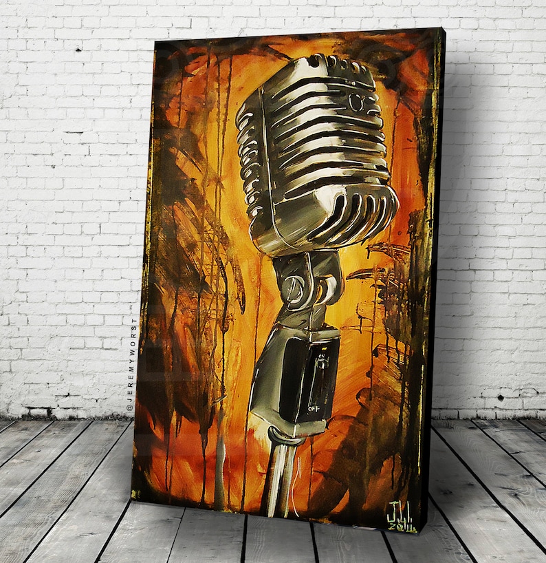 May include: A vintage-style microphone with a silver finish and a black stand. The microphone is set against a background of orange, yellow, and brown paint splatters.