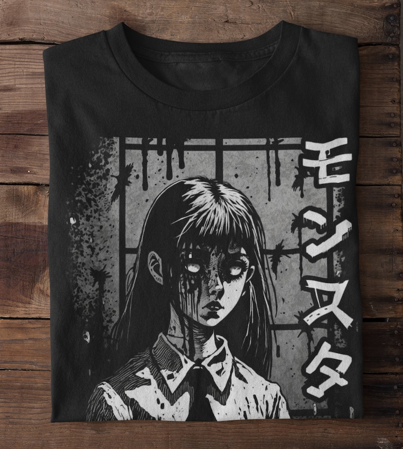 May include: Black and white graphic t-shirt featuring a girl with blood dripping from her eyes and mouth. The girl is wearing a white shirt with a black tie. The background is a gray brick wall with barbed wire. The text "生ける屍" is written in Japanese on the right side of the shirt.