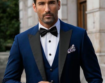 May include: A navy blue three-piece suit with a black lapel and a black bow tie. The suit includes a vest and a pocket square with a floral pattern. The text "Chic Prime" is visible at the bottom.