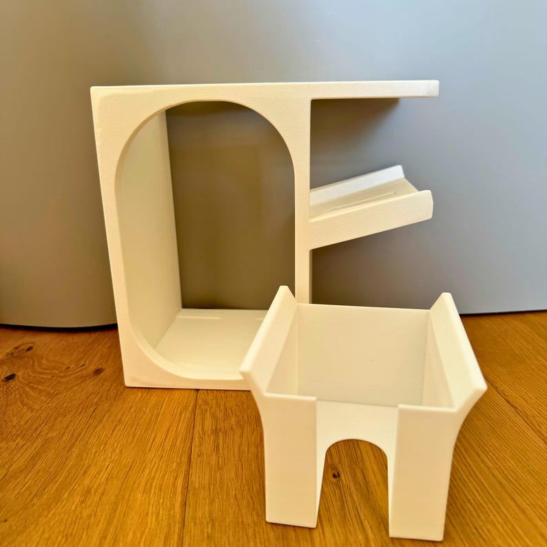 May include: White plastic organizer with multiple shelves and compartments. The organizer is designed to hold various items, such as toiletries, makeup, or office supplies.