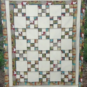 May include: A white quilt with a patchwork design featuring a variety of animal prints in shades of brown, green, and blue. The quilt is bordered with a brown, green, and blue patterned fabric.