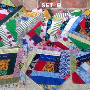 May include: A collection of multi-colored fabric quilt blocks arranged in a group, featuring various patterns including strawberries, floral prints, and stripes. Several blocks contain embroidered text such as SET B, BLUEBIRDS AND TULIPS, PRIMITIVE HEARTS, BLUESBIRDS GALORE, and FANCY GOLD TULIPS.