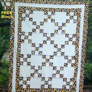 May include: A quilt block with a white background and a black and yellow pattern. The block is surrounded by a border of yellow and black fabric with a popcorn pattern. The text "FREE Block" is visible in the upper left corner of the image.