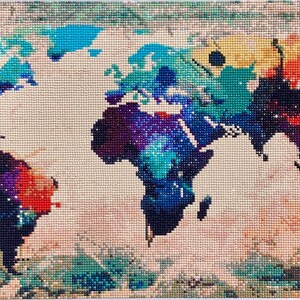 May include: A colourful world map with a watercolour effect. The map is on a beige background and is made of small, colourful squares.
