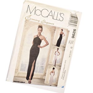 May include: A McCalls Evening Elegance sewing pattern envelope, number 9296, size D (12, 14, 16). The front displays illustrations of floor-length dresses with halter necklines and side slits, labeled as Petite-Able, featuring both black and white versions.