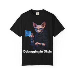 May include: Black t-shirt with a Sphynx cat wearing glasses and a hoodie, pointing at a digital screen. The cat is shown with a keyboard and the text "Debugging in Style" in white.