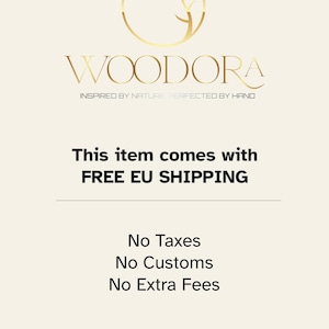 May include: A graphic design featuring a gold circular logo with a stylized tree branch inside, positioned above the text WOODORA in a serif font, followed by the tagline INSPIRED BY NATURE PERFECTED BY HAND in a smaller sans-serif font.