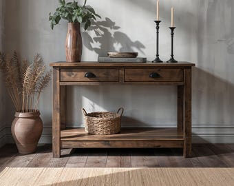 May include: A rectangular wooden console table featuring two drawers with black semi-circular pulls and a lower shelf. The table is constructed from dark brown wood with a visible grain pattern and stands on four straight legs, providing a sturdy surface.