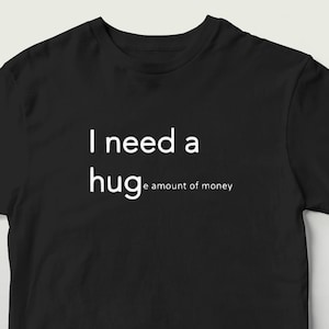 Funny &quot;I Need a Huge Amount of Money&quot; T-Shirt – Minimalist Sarcastic Tee | Clever Wordplay Shirt | Black Unisex Graphic Gift