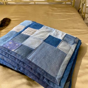 • Material: Made with high-quality, upcycled denim and soft cotton fabric for durability and comfort.
 • Design: A beautiful patchwork pattern featuring various shades of blue, accented by pops of color for a modern, rustic aesthetic.