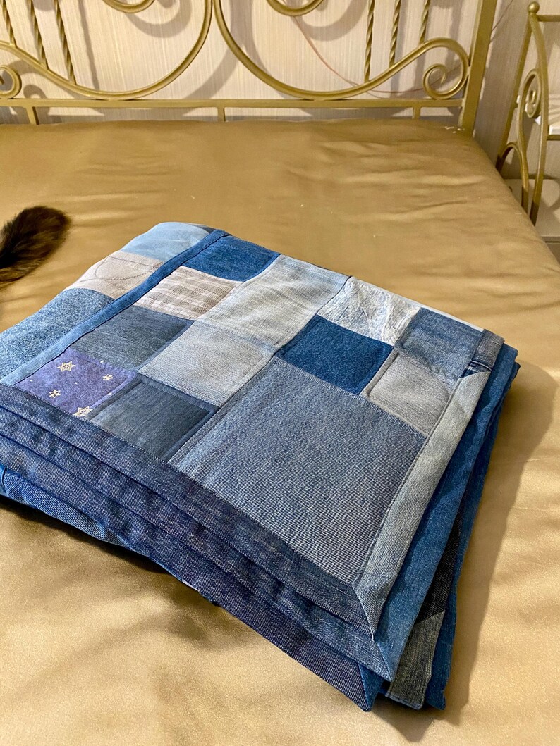 • Material: Made with high-quality, upcycled denim and soft cotton fabric for durability and comfort.
 • Design: A beautiful patchwork pattern featuring various shades of blue, accented by pops of color for a modern, rustic aesthetic.