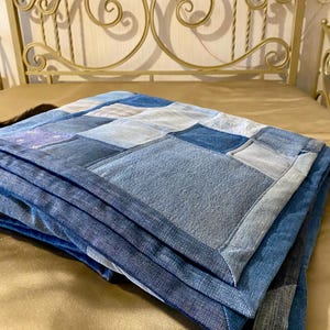 • Material: Made with high-quality, upcycled denim and soft cotton fabric for durability and comfort.
 • Design: A beautiful patchwork pattern featuring various shades of blue, accented by pops of color for a modern, rustic aesthetic.