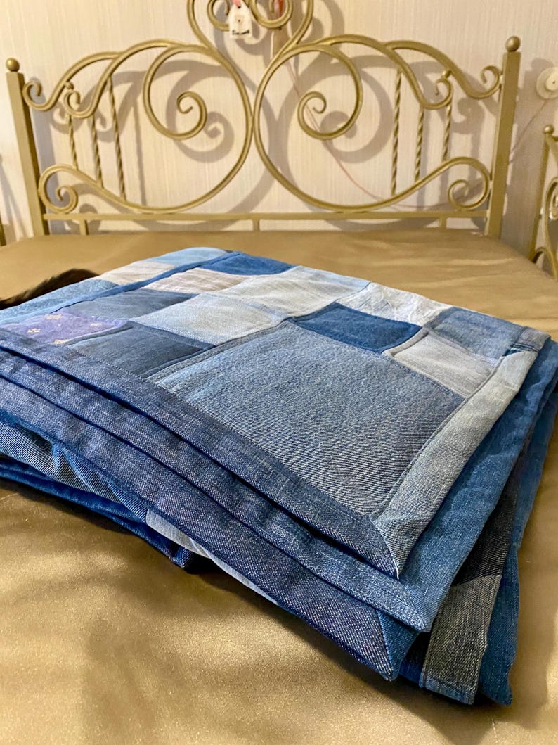 • Material: Made with high-quality, upcycled denim and soft cotton fabric for durability and comfort.
 • Design: A beautiful patchwork pattern featuring various shades of blue, accented by pops of color for a modern, rustic aesthetic.