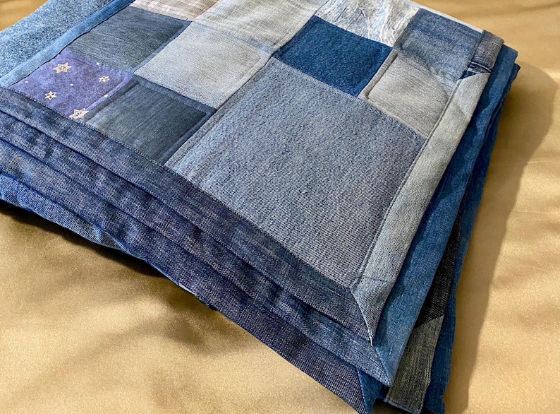 • Material: Made with high-quality, upcycled denim and soft cotton fabric for durability and comfort.
 • Design: A beautiful patchwork pattern featuring various shades of blue, accented by pops of color for a modern, rustic aesthetic.