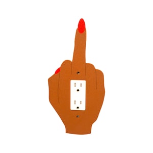 May include: A brown wall plate shaped like a hand giving the middle finger. The fingernail is painted red. The plate has a white electrical outlet with two sockets.
