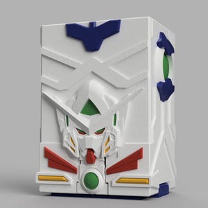 May include: A white rectangular storage box featuring a moulded relief of a robotic head on the front. The design includes blue, green, red, and yellow accents, with a prominent V-shaped crest on the forehead and a circular green emblem at the base.