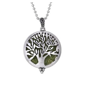 May include: A white ceramic mug with a black handle and the text "But First, Coffee" in a bold, black font. The mug is set against a blurred background. The mug appears to be approximately 10 cm tall.