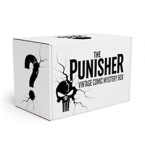 Puede incluir: Caja blanca con un signo de interrogación negro y el texto "THE PUNISHER VINTAGE COMIC MYSTERY BOX." El diseño de la caja incluye un efecto de grieta y un cráneo negro.