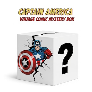Puede incluir: Una caja blanca con las palabras "CAPTAIN AMERICA VINTAGE COMIC MYSTERY BOX" en amarillo y rojo. La caja presenta a Capitán América rompiendo una pared, sosteniendo su escudo y un gran signo de interrogación negro.
