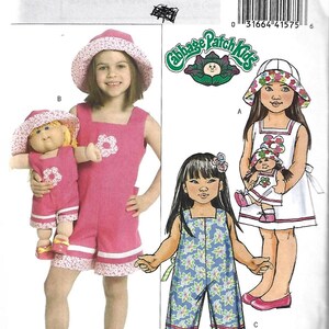 May include: Butterick B5018 sewing pattern envelope featuring Cabbage Patch Kids designs. Includes illustrations and photographs of children and dolls wearing matching outfits, such as a pink romper, a white dress, and a blue floral jumpsuit with hats.