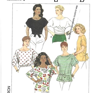 May include: Simplicity sewing pattern 9629 for tops, featuring five variations including a black wrap top, a white top with red polka dots, a green and white striped top with a tie waist, a yellow top with a back tie, and a floral print top.