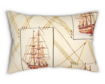May include: Rectangular pillow with a cream background featuring a repeating pattern of vintage sailing ships in red and brown, with brown lines and rectangles. The pillow has a soft, textured appearance.