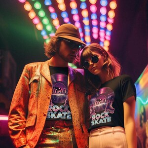May include: A couple wearing matching black t-shirts with a graphic of a vinyl record and the words "ROCK SKATE". The man wears a brown hat and orange jacket. The woman wears sunglasses. The background has colorful lights.