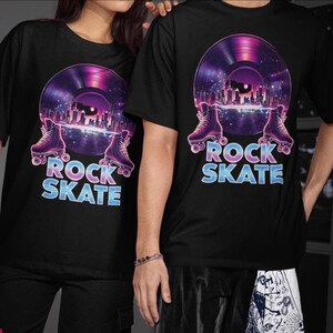 May include: Black t-shirts with a graphic design featuring a purple and pink vinyl record with roller skates and a city skyline. The text "ROCK SKATE" is in blue and purple.