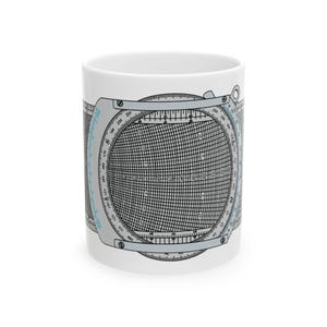 May include: White ceramic mug featuring a detailed illustration of a circular slide rule, with gray and black grid lines and scales. The design wraps around the mug, showcasing the instrument's intricate details.
