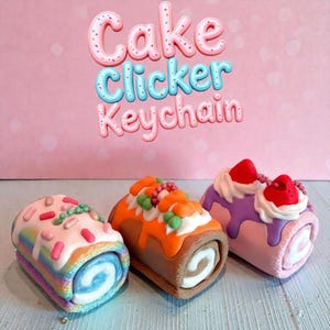 May include: Three colorful cake roll keychains. The keychains are decorated with frosting and toppings, including sprinkles, fruit, and cream. The text "Cake Clicker Keychain" is displayed above the keychains on a pink background.