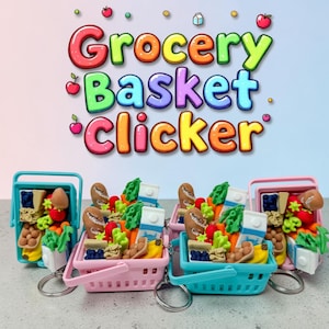 May include: Miniature grocery basket keychains in pink, teal, and blue, filled with tiny food items like bread, fruit, and vegetables. The text "Grocery Basket Clicker" is displayed above the keychains in colorful bubble letters. Each basket has a silver keyring.